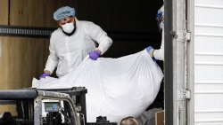 Body being loaded onto refrigerator truck